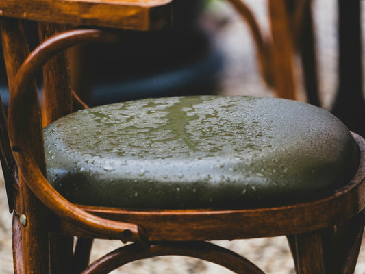 Wet chair seat with water droplets on it