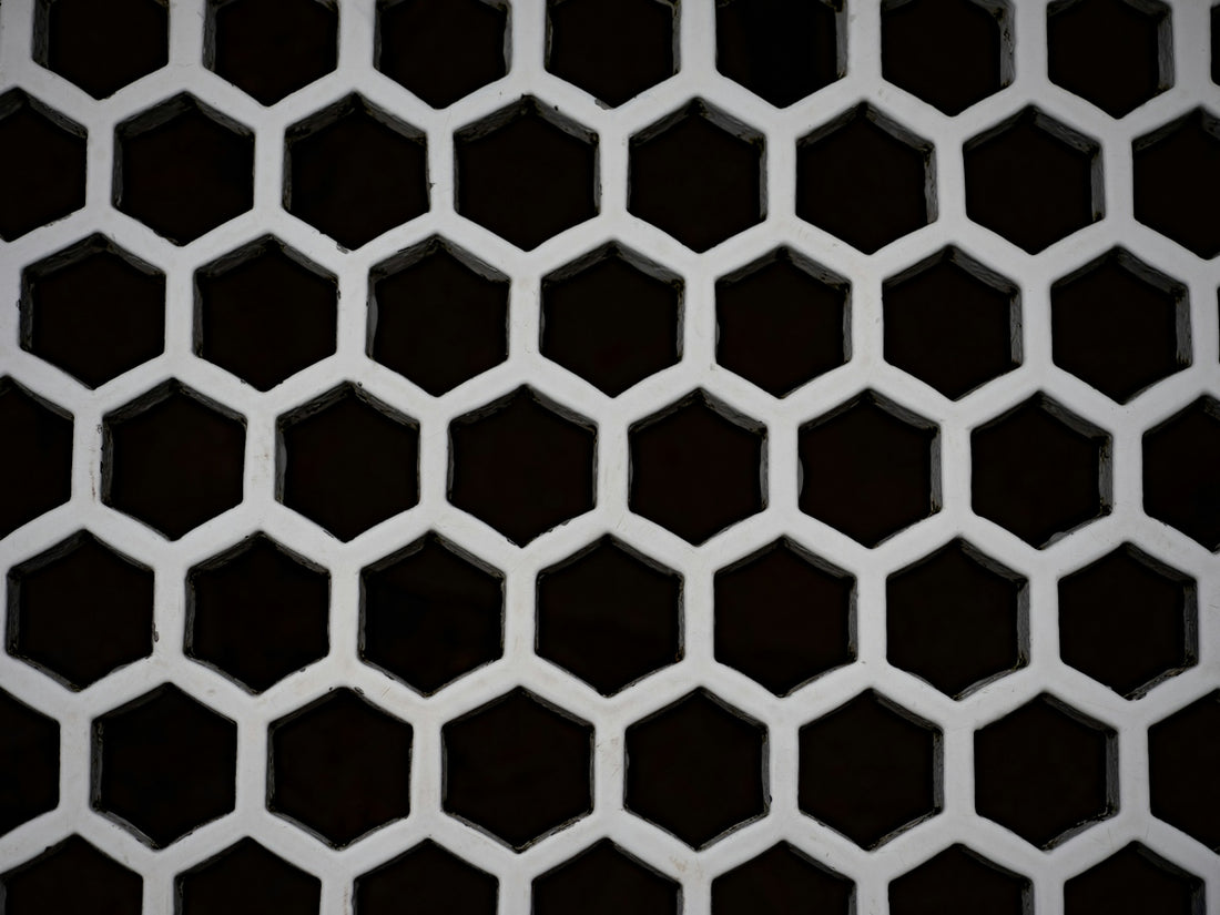 A white honeycomb pattern against a dark background