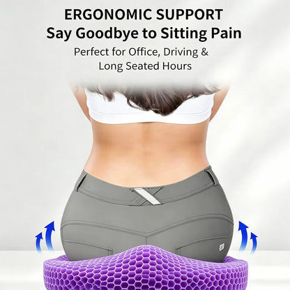 A person shown from the back wearing gray fitted shorts and a white sports bra, seated on a purple honeycomb ergonomic cushion with text above reading 'ERGONOMIC SUPPORT Say Goodbye to Sitting Pain' and blue arrows indicating support.