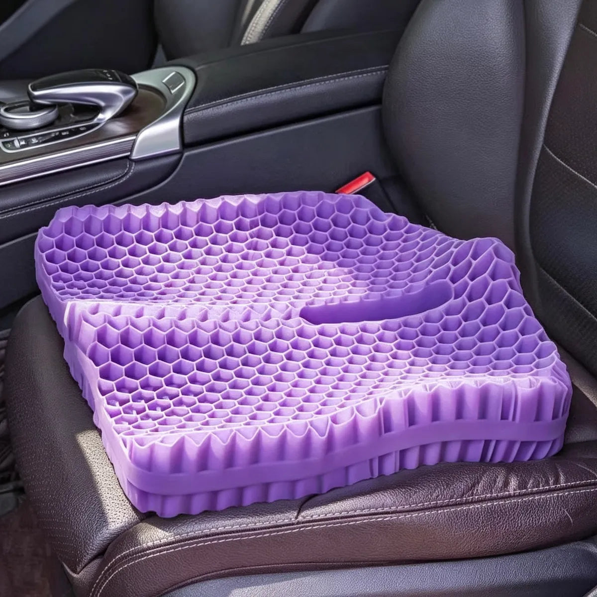 Purple honeycomb seat cushion with a central cutout on a car seat.