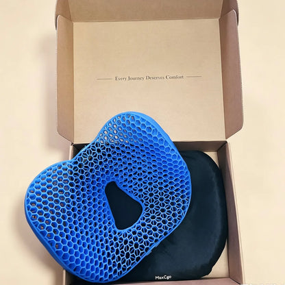 Blue honeycomb TPE seat cushion with a tailbone cutout shown with its black cover in an open MaxCgo box.