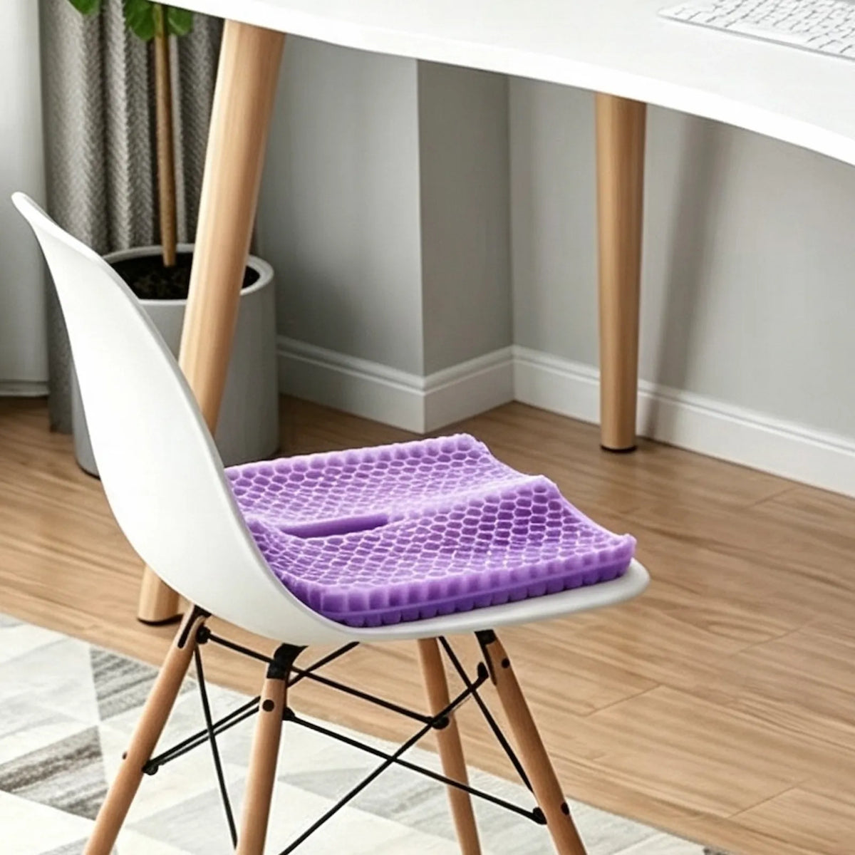 Purple honeycomb seat cushion on a white chair at a home office desk.