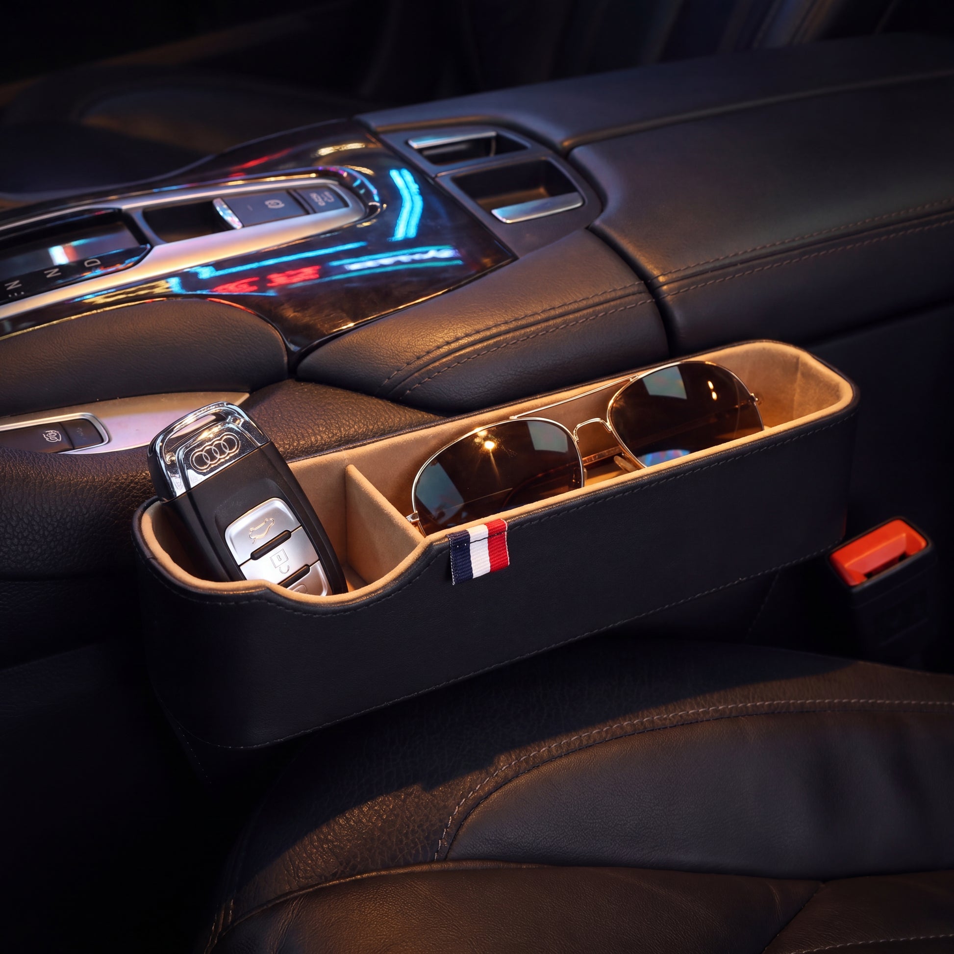 Car Seat Gap Organizer - close-up detail showing premium PU leather stitching and French ribbon badge