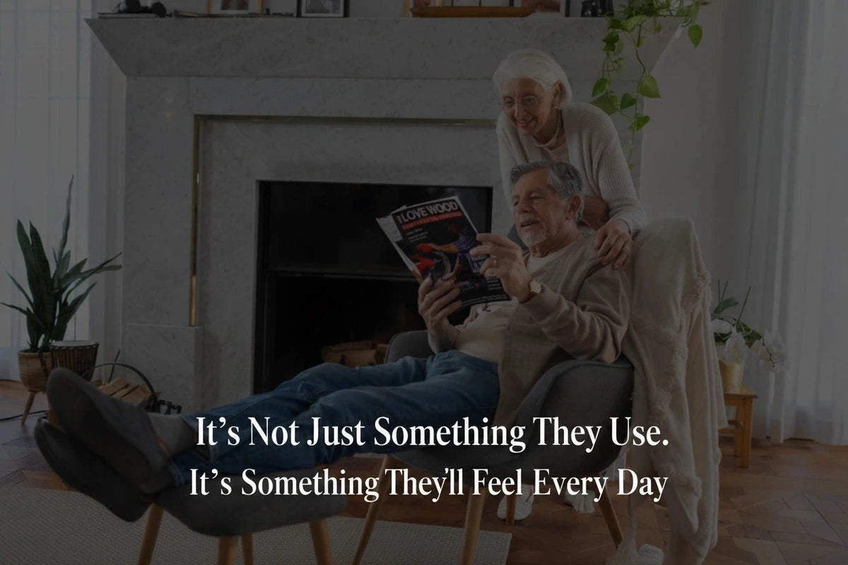 An elderly couple relaxes in a living room by a fireplace, with the man reading a magazine while the woman sits behind him. A large text overlay reads, 'It's Not Just Something They Use.